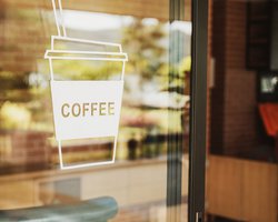 Luxury-coffee-shop-sign-on-the-glass-door at Emerald Springs Townhomes in Detroit, MI